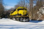 SU-99-22 grinds  uphill through town on an overcast monday eveing with a borrowed CSXT SD40-2 leading